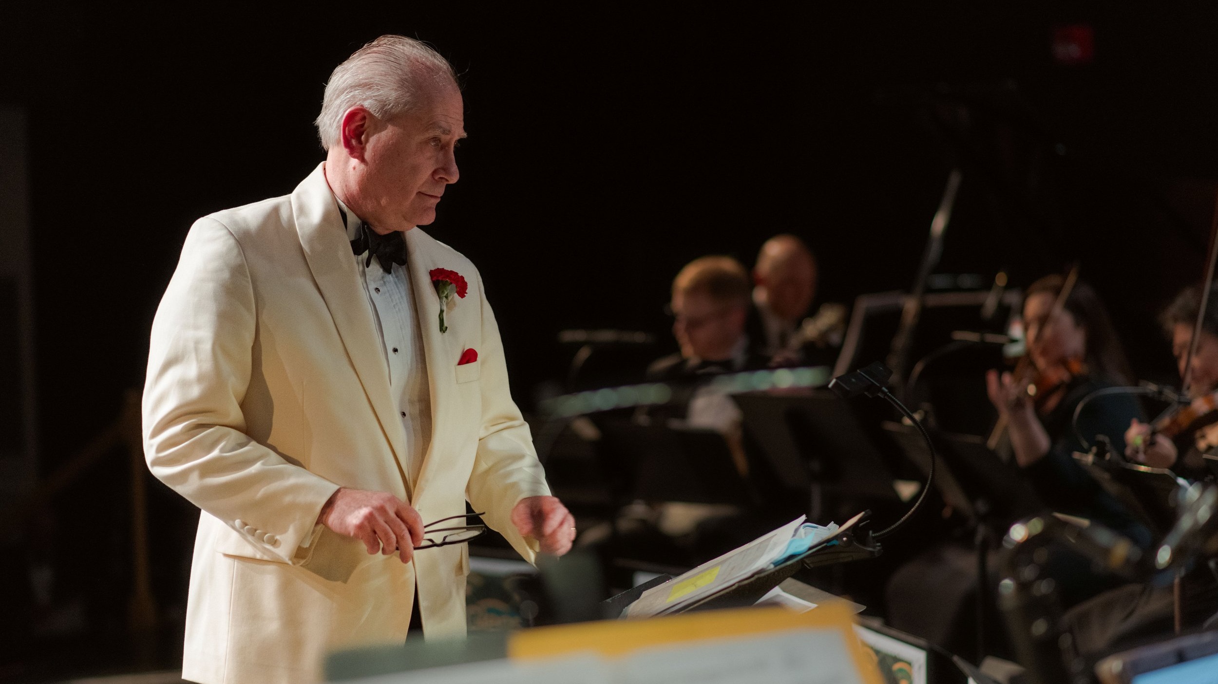 Charles Peltz conducting in formal attire